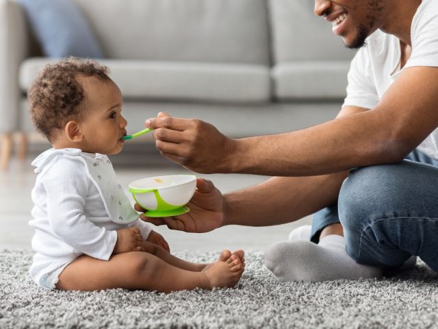 Child being fed baby food