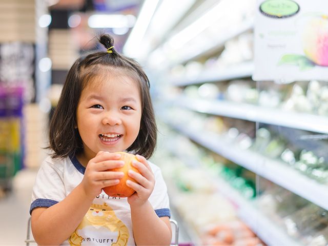 Child holding an apple
