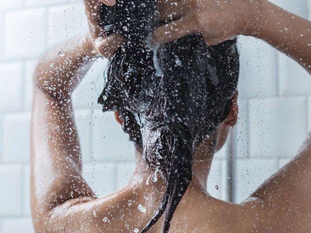 Woman applying shampoo