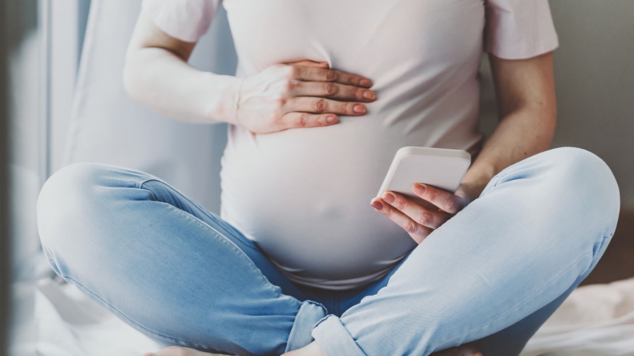 Pregnant person using cellphone